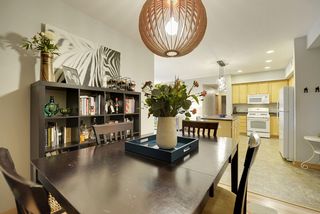 The Dining Room features this unique Light Fixture & Hardwood Floors! 