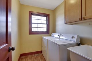 Nicely sized laundry room includes washer/dryer and large laundry tub/sink.