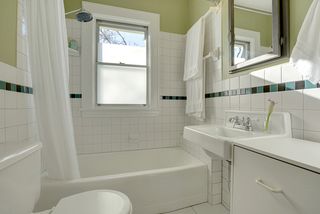 The Light-Filled Bathroom features Ceramic Tile Floors & Tile Surrounds
