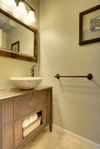 Don't miss the Main Floor Half-Bathroom with Custom Vanity & Stone Vessel Sink! 
