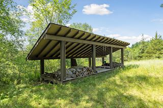 Custom built wood storage with room for swings! 