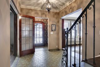 The Grand Entry Foyer features original tile, wrought iron railings and beautiful doors...