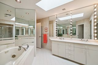 Primary 5 piece bath with jetted tub and water closet.