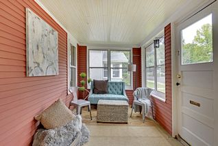 Lovely sunroom in front of the home - light-filled and airy!