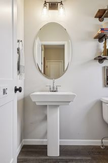 A pedestal sink in the main level powder bath adds charm 
and is convenient for everyone.