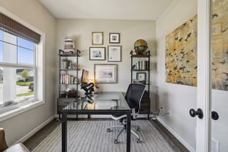 The main level home office or flex room is flooded with natural light.  
The glass front french doors offer privacy while getting some work accomplished.