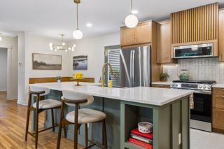 A built-in island book shelf houses all your favorite cookbooks to inspire you in your brand new kitchen - beautiful new cabinets with soft-close drawers & cabinets, new appliances, gorgeous backsplash highlighted by under cabinet lighting...