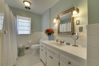 Bright & Cheery! The Main Floor Bathroom features the original "Retro" Tile...