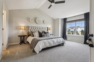 The primary suite boasts a vaulted ceiling, huge windows 
a ceiling fan with light fixture.