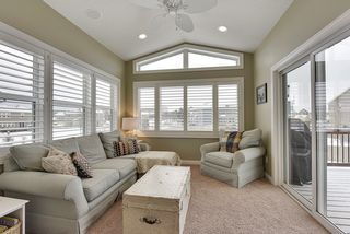 4-Season Sunroom with vaulted ceiling, facing South, and flooded with light. Opens to large cedar deck with outdoor speakers, and stairs to yard.