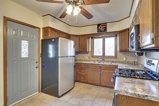 Tiled back splash and floors, over-sized refrigerator. 