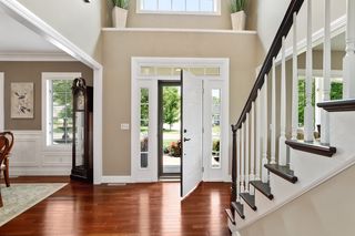 The foyer greets you with tigerwood hardwood flooring and high ceilings