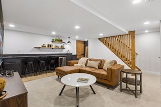 No family room would be complete without a wine 'cellar' tucked behind a custom oak door seen at center of photo...extra but you deserve it