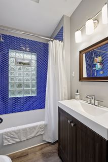 View of Updated Bathroom in Apt #4.
New Tile, Tub, Toilet, Vanity, Sink, Faucet, Lighting and Vinyl Flooring.