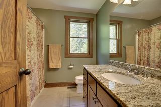 Upper hall bath, granite counters, ceramic floors.