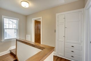 Upper level hall with plentiful linen storage.