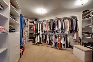 Large walk in closet with built ins.