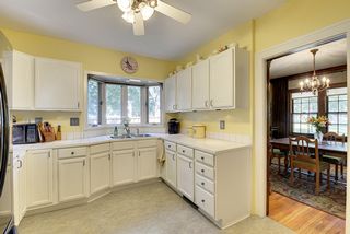 The Light-Filled Kitchen offers plenty of Cabinet Space & Views of the Side Yard.