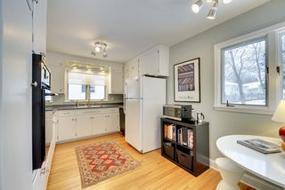 The Bright & Cheery Kitchen features Hardwood Floors and views of the Back Yard! 
