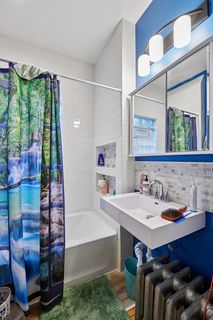 View of Updated Bathroom in Apt.#1
Features all new Tub, Over-sized Subway Tile, Vinyl flooring, Sink, Toilet, Faucet, lighting & Med Cabinet.