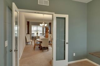 Double door entrance to the office looking back to the formal dining room