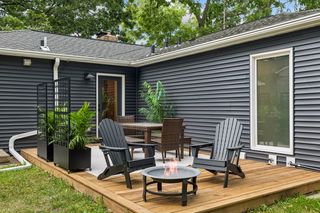 New contrasting vinyl siding creates it's own unique outdoor space sizable enough for a dining and relaxing space