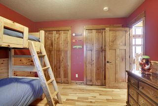 No shortage of closet space here! The four-paneled doors blend another natural wood into the space.