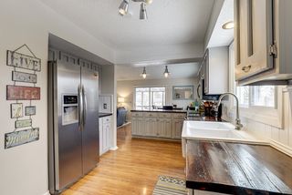 Kitchen open to informal dining overlooking screened porch...