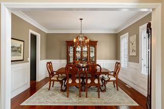 Dining room has crown molding and wainscoting