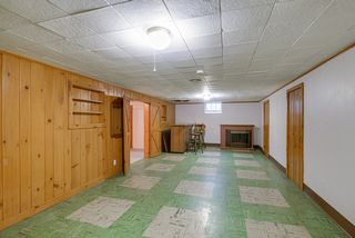 Finished portion of the basement with a bar area and an electric fireplace