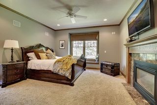 Main floor Master Bedroom flanked by a window seat overlooking the backyard and wooded area.