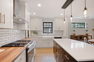 Walnut butcher-block countertop, subway tile backsplashes, commercial range hood,  high-end soft-close cabinets