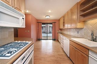Handsome kitchen with custom cabinetry and informal dining.  Opens to patio.