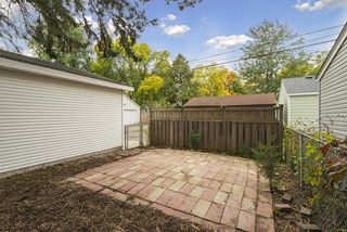 Patio in backyard offers plenty of privacy for entertaining or relaxing.