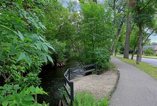 5024 Park Avenue - Step across the street and you are here at Minnehaha Creek - note the people canoeing!