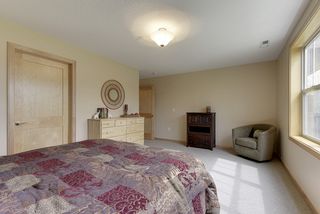 Large adjoining walk-in closet behind wood paneled doors.  