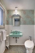 The Main Floor Half Bathroom features original fixtures and beautiful tile...