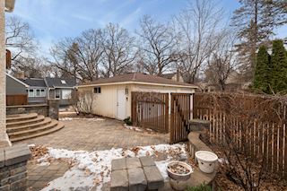 Pavered Patio at back door leading to the three car garage and back yard