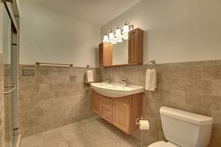Main floor bath with double sinks and cabinetry.