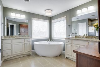 Beautifully remodeled master bath with dual vanities, heated floor, all new fixtures and lighting