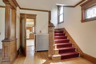 The Entry Foyer is BEAUTIFUL! Columns, Original Newel Post & Leaded Glass Windows grace this space...