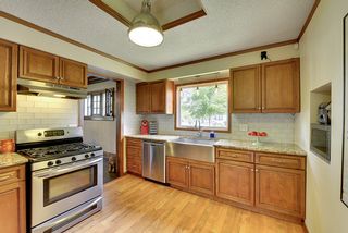 The Kitchen features Hardwood Floors, Stainless Steel Appliances & "Farm Style" Sink...