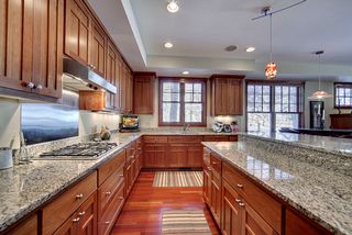 Granite Counter surfaces with granite backslashes. Stainless backsplash over cooktop.
