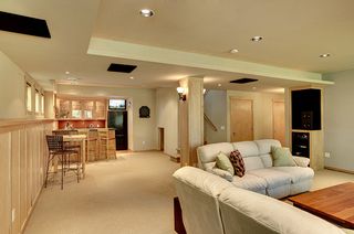 Wet bar flanks home theater seating - perfect entertaining combination