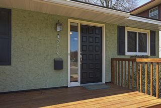 Black shutters and door, white trim and chrome lights set the tone.