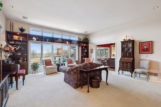 Spacious living room with built-ins around the large bank of windows.