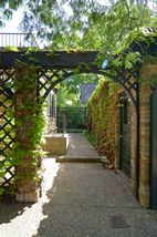 Truly beautiful! Enjoy the exposed aggregate walkways & vine covered pathways that surround the home...