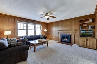 Richly paneled den/family room - with cozy wood fireplace