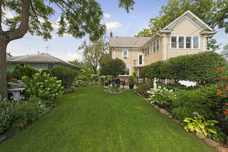 AMAZING! The HUGE Corner Lot features Mature Gardens and Water Feature! 