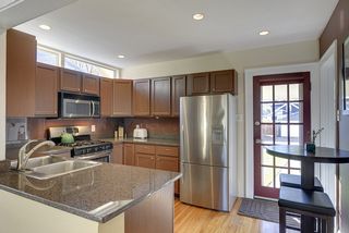 The Light-Filled Kitchen features Recessed Lighting, Hardwood Floors and Transom Windows
